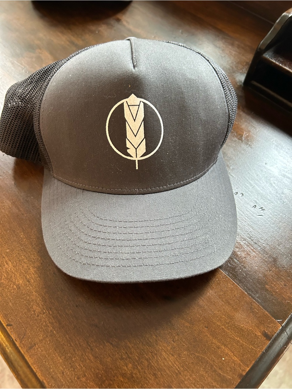Black Trucker Hat with White Feather Logo